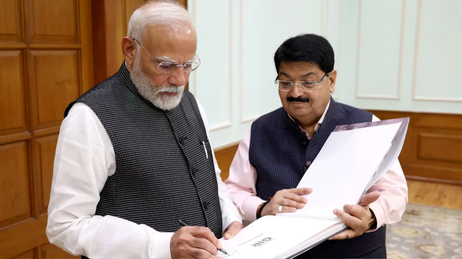 Picture of MP Parimal Nathwani presents his book 'Call of the Gir' to Prime Minister Narendra Modi